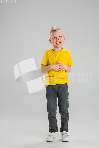 Image of Happy boy isolated on white studio background. Looks happy, cheerful, sincere. Copyspace. Childhood, education, emotions concept