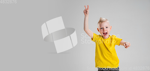 Image of Happy boy isolated on white studio background. Looks happy, cheerful, sincere. Copyspace. Childhood, education, emotions concept