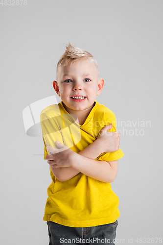 Image of Happy boy isolated on white studio background. Looks happy, cheerful, sincere. Copyspace. Childhood, education, emotions concept