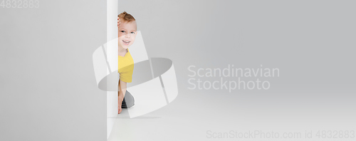 Image of Happy boy isolated on white studio background. Looks happy, cheerful, sincere. Copyspace. Childhood, education, emotions concept