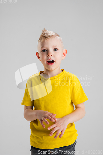 Image of Happy boy isolated on white studio background. Looks happy, cheerful, sincere. Copyspace. Childhood, education, emotions concept