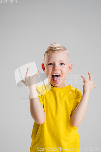 Image of Happy boy isolated on white studio background. Looks happy, cheerful, sincere. Copyspace. Childhood, education, emotions concept