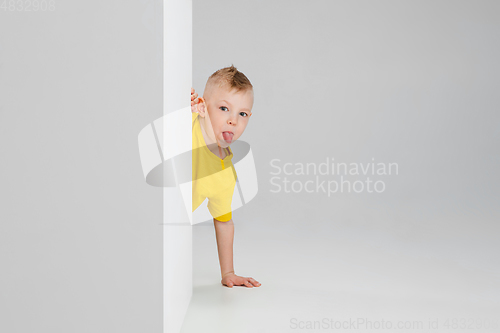 Image of Happy boy isolated on white studio background. Looks happy, cheerful, sincere. Copyspace. Childhood, education, emotions concept