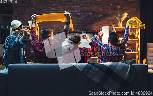 Image of Group of friends watching TV, sport match together. Emotional fans cheering for favourite team, watching on exciting game. Concept of friendship, leisure activity, emotions