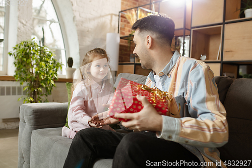 Image of Happy father and little cute daughter at home. Family time, togehterness, parenting and happy childhood concept. Weekend with sincere emotions.