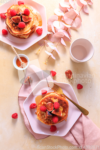 Image of Sweet curd cheese pancakes with fresh raspberry, figs and maple sirup