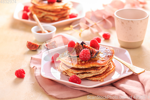 Image of Sweet curd cheese pancakes with fresh raspberry, figs and maple sirup