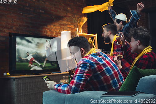 Image of Group of friends watching TV, sport match together. Emotional fans cheering for favourite team, watching on exciting game. Concept of friendship, leisure activity, emotions