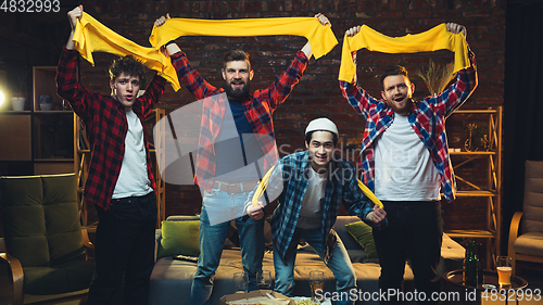 Image of Group of friends watching TV, sport match together. Emotional fans cheering for favourite team, watching on exciting game. Concept of friendship, leisure activity, emotions