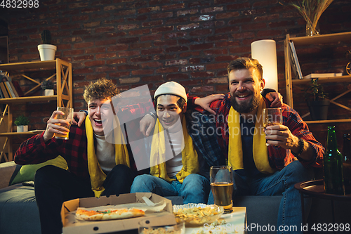 Image of Group of friends watching TV, sport match together. Emotional fans cheering for favourite team, watching on exciting game. Concept of friendship, leisure activity, emotions