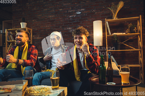 Image of Group of friends watching TV, sport match together. Emotional fans cheering for favourite team, watching on exciting game. Concept of friendship, leisure activity, emotions