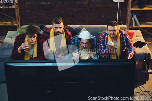 Image of Group of friends watching TV, sport match together. Emotional fans cheering for favourite team, watching on exciting game. Concept of friendship, leisure activity, emotions