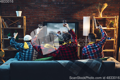 Image of Group of friends watching TV, sport match together. Emotional fans cheering for favourite team. Top view. Concept of friendship, leisure activity, emotions