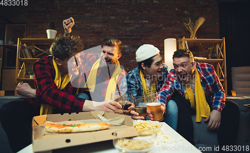 Image of Group of friends watching TV, sport match together. Emotional fans cheering for favourite team, watching on exciting game. Concept of friendship, leisure activity, emotions