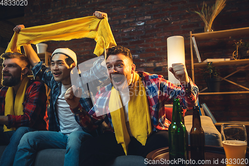 Image of Group of friends watching TV, sport match together. Emotional fans cheering for favourite team, watching on exciting game. Concept of friendship, leisure activity, emotions