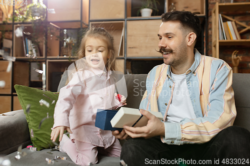 Image of Happy father and little cute daughter at home. Family time, togehterness, parenting and happy childhood concept. Weekend with sincere emotions.