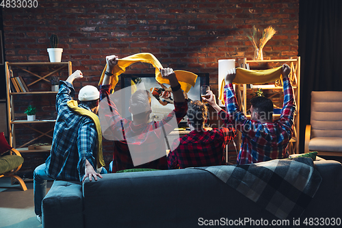 Image of Group of friends watching TV, sport match together. Emotional fans cheering for favourite team. Top view. Concept of friendship, leisure activity, emotions