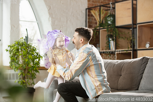 Image of Happy father and little cute daughter at home. Family time, togehterness, parenting and happy childhood concept. Weekend with sincere emotions.