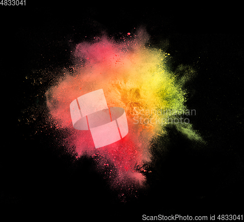 Image of Explosion of colored, fluid and neoned powder on black studio background with copyspace