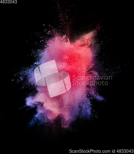 Image of Explosion of colored, fluid and neoned powder on black studio background with copyspace