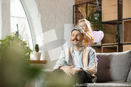 Image of Happy father and little cute daughter at home. Family time, togehterness, parenting and happy childhood concept. Weekend with sincere emotions.