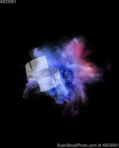 Image of Explosion of colored, fluid and neoned powder on black studio background with copyspace