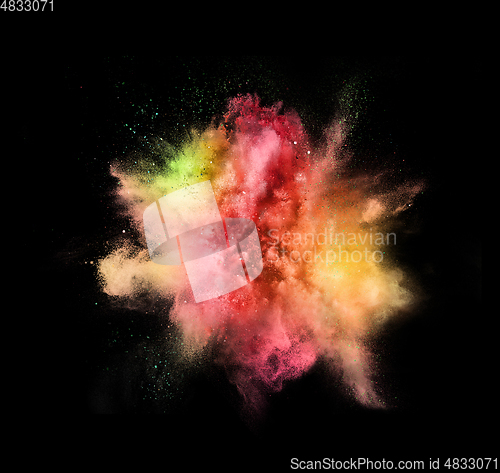 Image of Explosion of colored, fluid and neoned powder on black studio background with copyspace