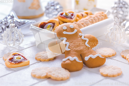 Image of Homemade Christmas cookies and gingerbread with ornaments in white