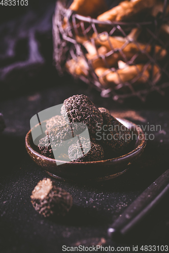 Image of Black truffle in bowl on dark background