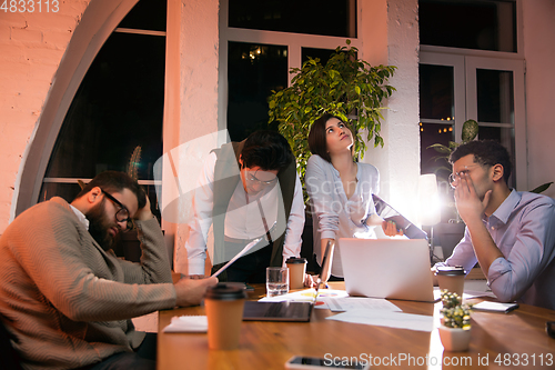 Image of Colleagues working together in modern office using devices and gadgets during creative meeting