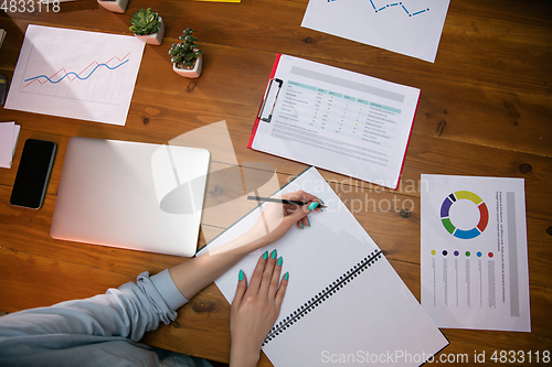 Image of Close up manager working in modern office using devices and gadgets during creative meeting