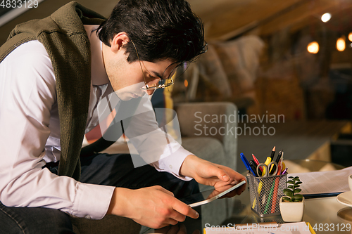 Image of Close up manager working in modern office using devices and gadgets during creative meeting