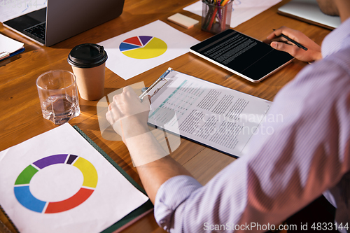 Image of Close up manager working in modern office using devices and gadgets during creative meeting