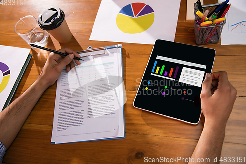 Image of Close up manager working in modern office using devices and gadgets during creative meeting