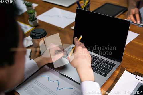 Image of Close up manager working in modern office using devices and gadgets during creative meeting