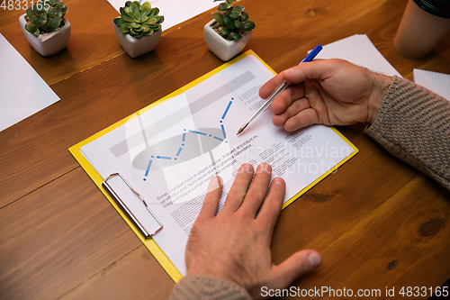 Image of Close up manager working in modern office using devices and gadgets during creative meeting