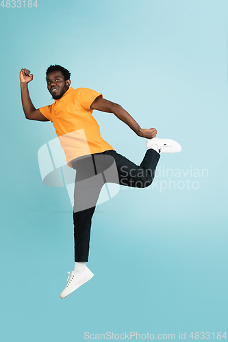 Image of Full length portrait of African young man isolated over blue studio background with copyspace