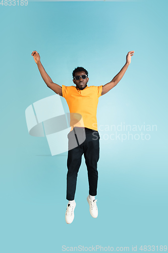 Image of Full length portrait of African young man isolated over blue studio background with copyspace