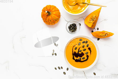 Image of Homemade pumpkin soup with pumpkin oil and seeds