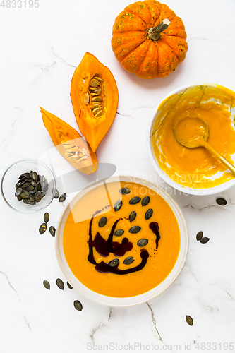 Image of Homemade pumpkin soup with pumpkin oil and seeds