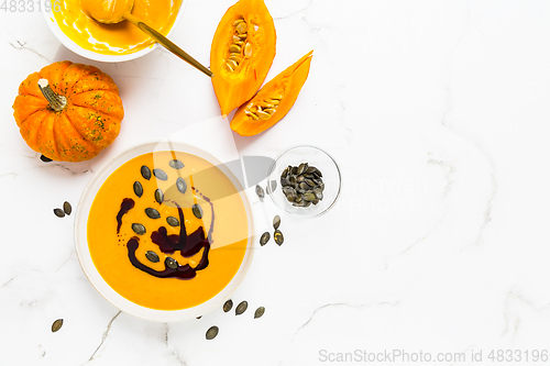 Image of Homemade pumpkin soup with pumpkin oil and seeds