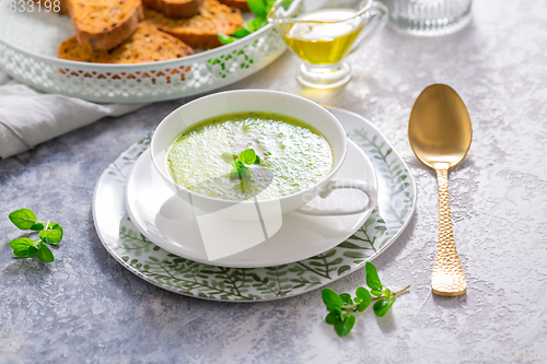 Image of Homemade zucchini soup with tomato ciabatta bread and herbs