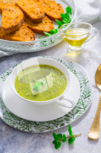 Image of Homemade zucchini soup with tomato ciabatta bread and herbs