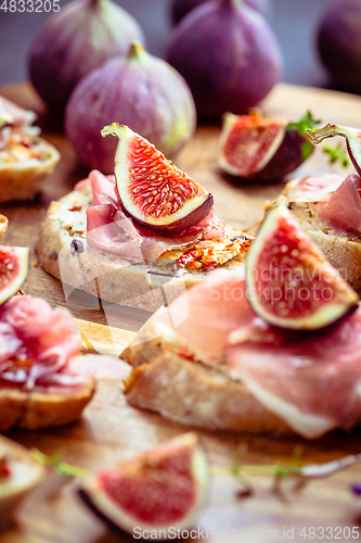 Image of Small open sandwiches with ciabatta, proscuitto and fresh figs