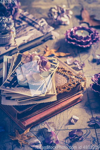 Image of Memories - old family photo album with necklace, old books and d
