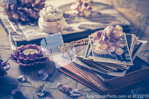 Image of Memories - old family photo album with necklace, old books and dried flowers