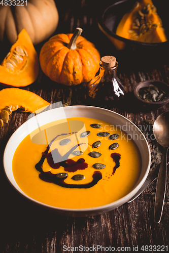 Image of Homemade pumpkin soup with pumpkin oil and seeds