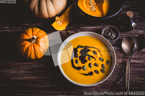 Image of Homemade pumpkin soup with pumpkin oil and seeds