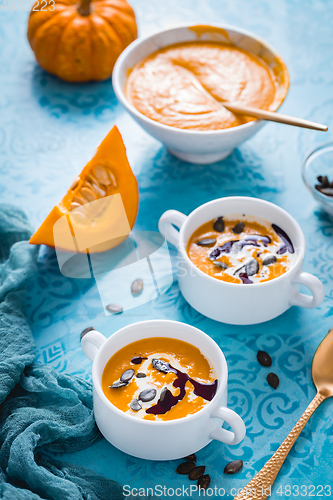 Image of Homemade pumpkin soup with coconut milk, pumpkin oil and seeds