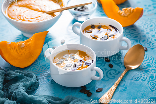 Image of Homemade pumpkin soup with coconut milk, pumpkin oil and seeds